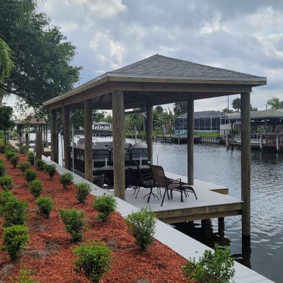 New vinyl seawall, composite decking and boat house with lift