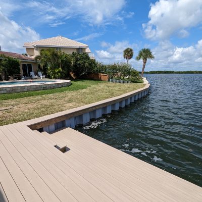 Curved seawall level with grass backyard